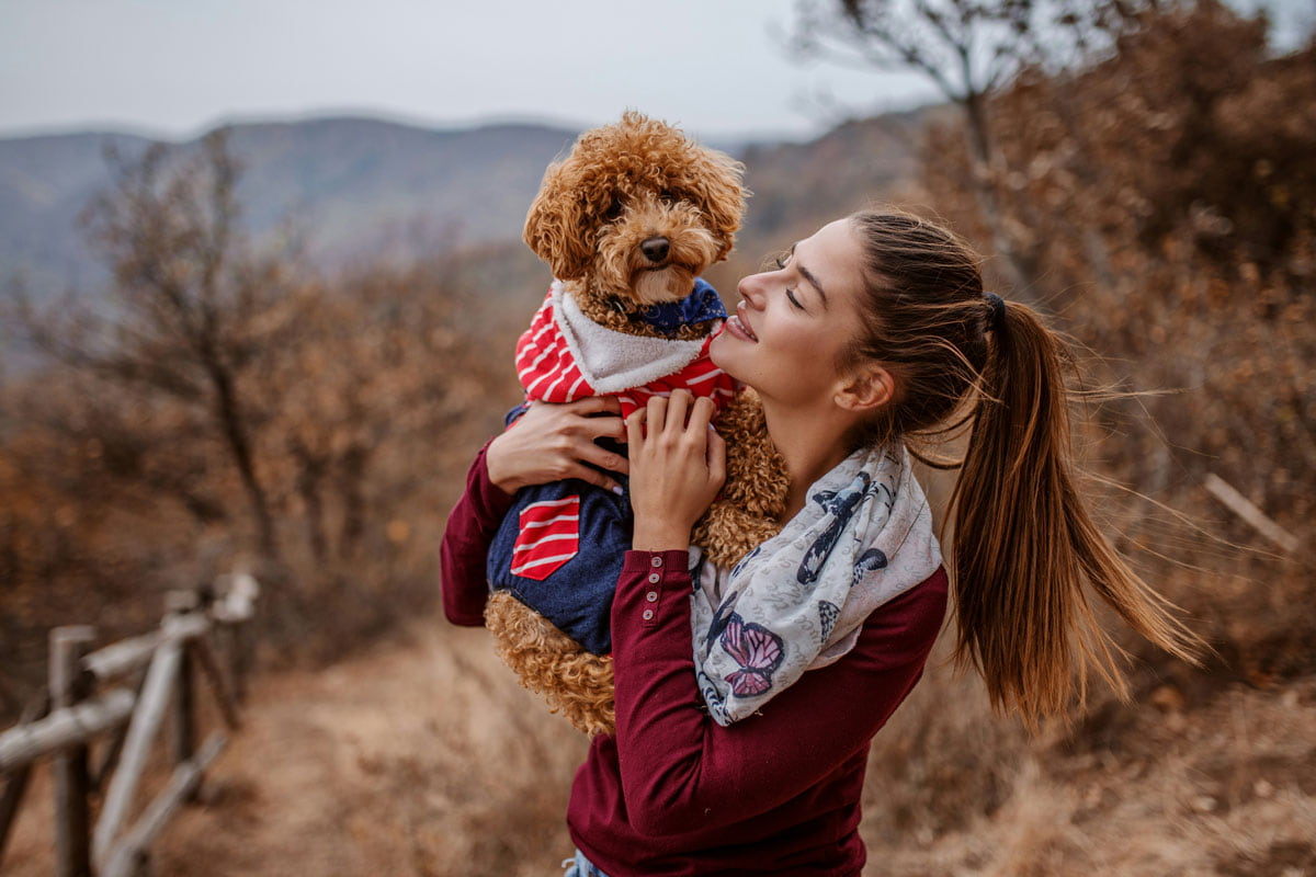 a-woman-and-her-cozy-pup-in-nature